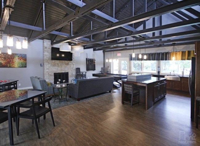 a large living room with a fireplace and a table and chairs